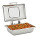 A Vollrath stainless steel chafing dish with a glass lid and a Super Pan V food container inside.