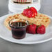 A plate of waffles topped with strawberries and Golden Barrel Sugar Free Pancake and Waffle Syrup.
