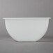 A white Choice condiment bowl with a lid on a gray surface.