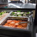 A black Cambro buffet with a variety of salads and vegetables on a counter.