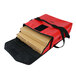A red and black Sterno insulated delivery bag with pizza boxes inside.