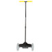 A black and yellow hand truck with wheels and a long black pole with a black handle.