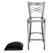 A Lancaster Table & Seating metal cross back bar stool with a black padded seat.