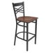 A Lancaster Table & Seating black and wood cross back bar stool with a wooden seat.