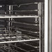 A stainless steel oven rack in a Cooking Performance Group electric convection oven.