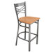 A Lancaster Table & Seating metal bar stool with a natural wood seat.