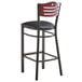 A Lancaster Table & Seating black bistro bar stool with a black vinyl seat and mahogany wood back with a black seat