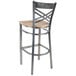 A Lancaster Table & Seating cross back bar stool with a wooden seat.