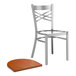 A Lancaster Table & Seating metal cross back chair with a wooden seat.