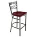 A Lancaster Table & Seating metal bar stool with a mahogany wood seat and a clear coat finish.