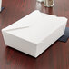 A white Fold-Pak Bio-Pak take-out box on a wood surface.
