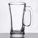 A clear Libbey glass beer mug with a handle.