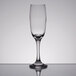 An Anchor Hocking Excellency flute wine glass on a reflective surface.