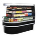 A Turbo Air black air curtain island display case full of drinks and beverages.