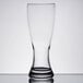 An Anchor Hocking Rim Tempered Pilsner Glass with a clear surface and a shadow.