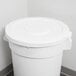 A white plastic Continental trash can lid on a white bucket.