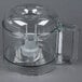 A clear plastic Robot Coupe cutter bowl with a handle.