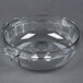 A clear plastic bowl with handles and a hole in the bottom.