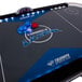 A Triumph Lumen-X Lazer air hockey table with blue and white lights.