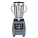 A Waring stainless steel food blender with a black top.