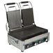 A Waring panini grill with two grooved and two smooth plates on a table in a professional kitchen.