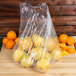 A plastic bag filled with lemons and oranges.