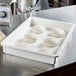 A white Cambro pizza dough proofing box holding a white ball of pizza dough on a table.