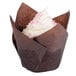 A Hoffmaster chocolate brown tulip baking cup with a cupcake inside.