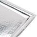 A white rectangular stainless steel tray with a hammered design.
