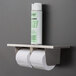 A Lavex stainless steel toilet paper dispenser with a shelf holding two rolls of toilet paper.