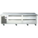 A Traulsen stainless steel commercial chef base with four freezer drawers on wheels.