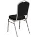 A Flash Furniture black and silver banquet chair with a black seat.