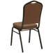 A brown Flash Furniture Hercules banquet chair with black metal legs.