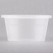 A Newspring clear oval plastic souffle container with a clear lid.