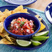 A blue plate with a bowl of Dei Fratelli Petite Diced Tomatoes with Juice and tortilla chips.