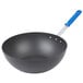 A black pan with a blue handle.