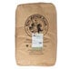 A brown bag of King Arthur Organic Whole Wheat Flour with a price tag.