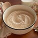 A bowl of King Arthur Organic Whole Wheat Flour with a spoon.