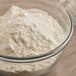 A bowl of King Arthur Organic Whole Wheat Flour with a whisk.