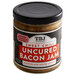 A jar of TBJ Gourmet Sweet Chili Uncured Bacon Jam with a black lid on a table.