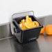 A San Jamar Mini Dome condiment holder with orange slices in it on a counter.