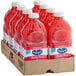 A case of eight red plastic bottles of Ocean Spray Ruby Red Grapefruit Juice.