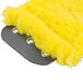 A close-up of a yellow Unger SmartColor MicroMop pad with holes.
