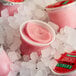 A group of red Luigi's Intermezzo cherry Italian ice cups on ice.