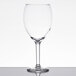 A Libbey Vino Grande wine glass on a white table.