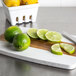 Fresh limes on a cutting board.