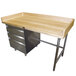 An Advance Tabco wood top baker's table with stainless steel legs and a left-side drawer unit.