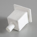 A white plastic drain catch with a square top.