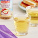 A couple of glasses of Nantucket Nectars Pressed Orchard Apple Juice on a table.