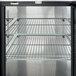 A stainless steel Avantco back bar refrigerator with shelves.